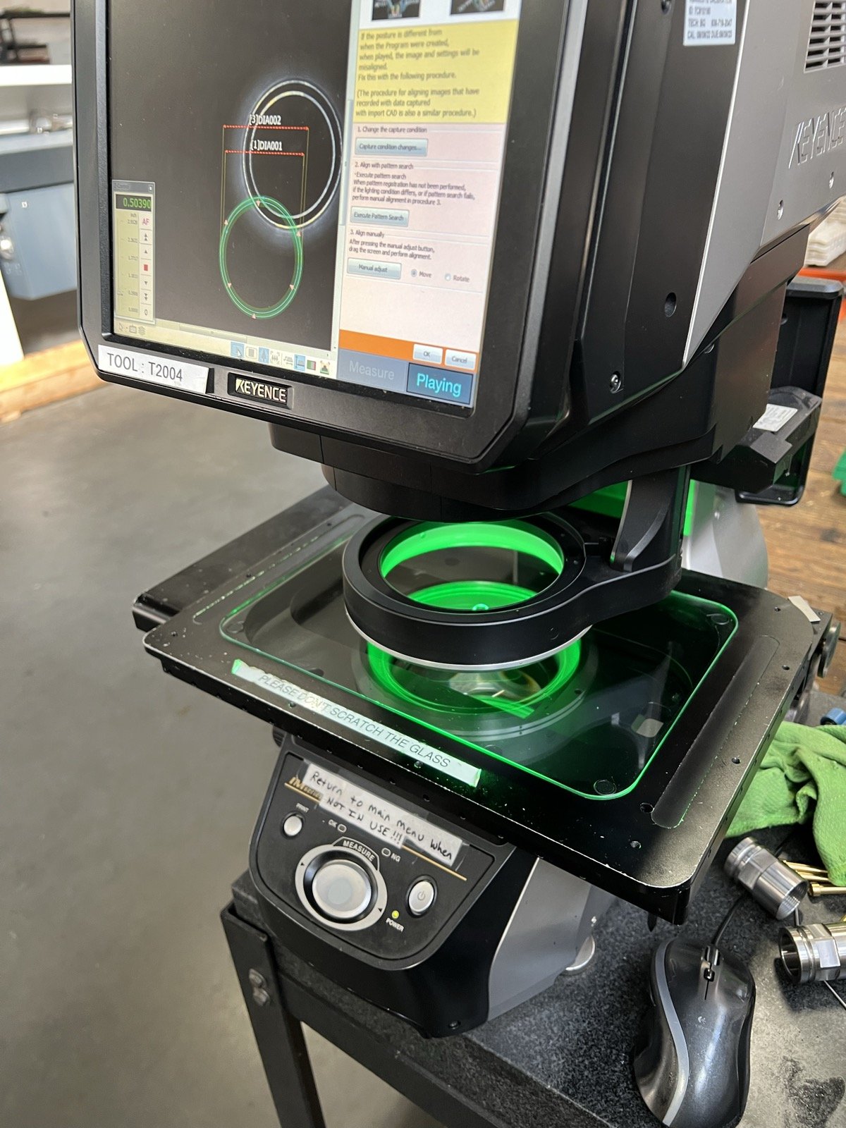TXSwiss Keyence optical comparator displaying dimensional measurement readings on screen during quality inspection of a precision-machined component